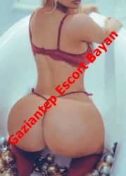 Escort advertisement: woman in red lingerie posing in a bathtub with a red diagonal overlay text Gaziantep Escort Bayan.
